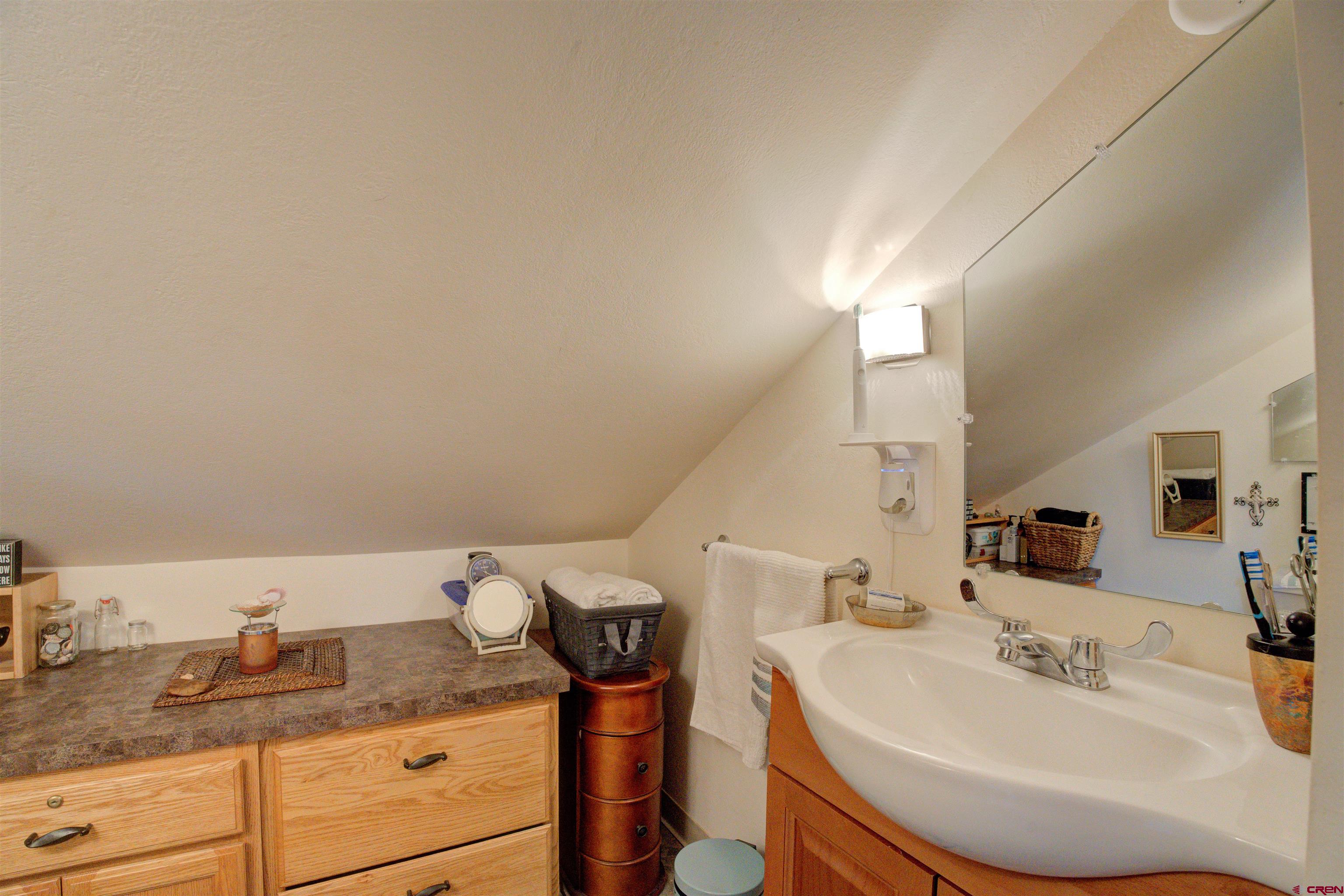 6597 Road 23 Cortez, CO 81321 - Photo 37 of 38 a bathroom with a sink and a mirror