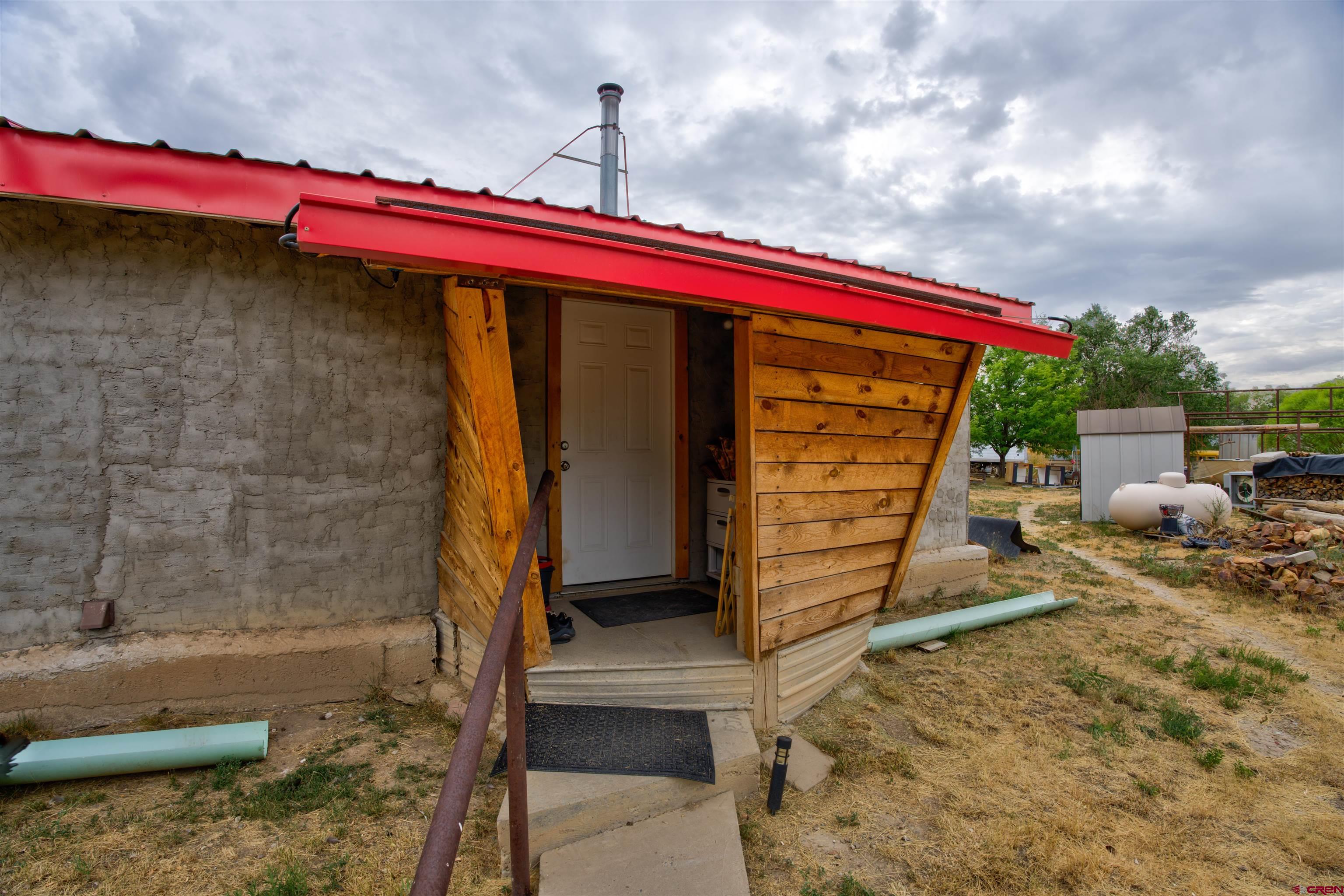6597 Road 23 Cortez, CO 81321 - Photo 5 of 38 a front view of a house with a yard