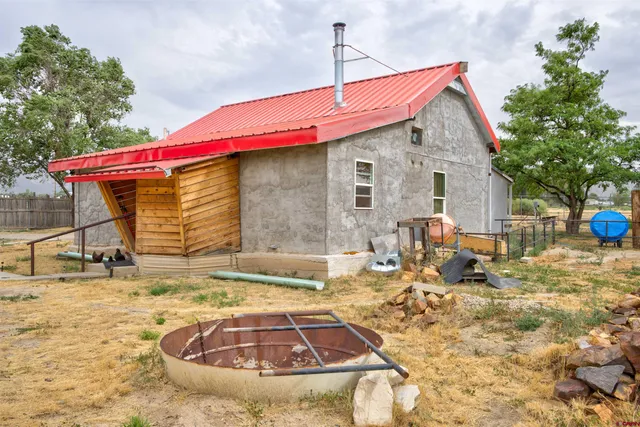 a backyard of a house with table and chairs