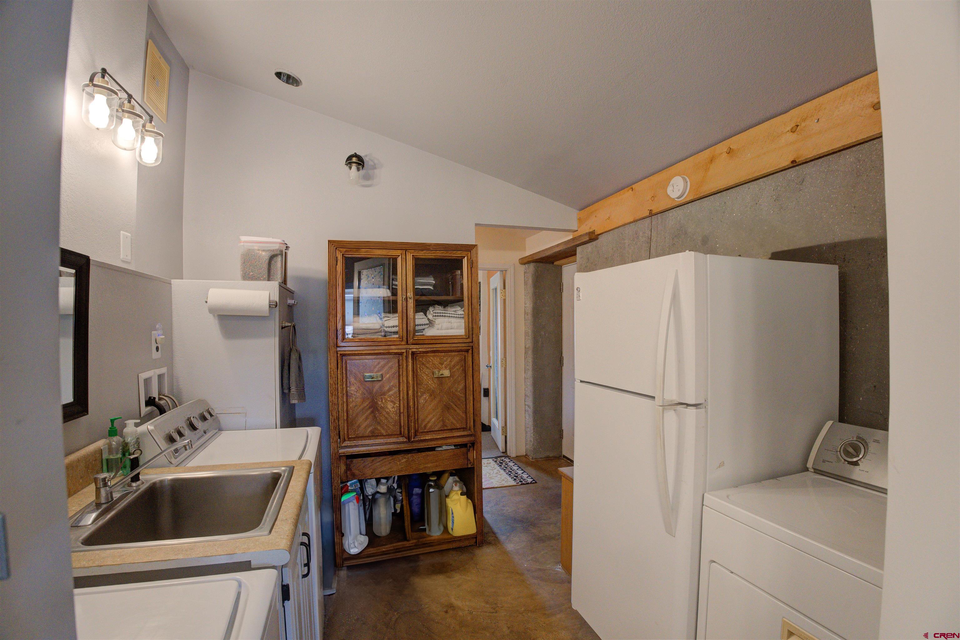 6597 Road 23 Cortez, CO 81321 - Photo 10 of 38 a room that has a sink and a refrigerator