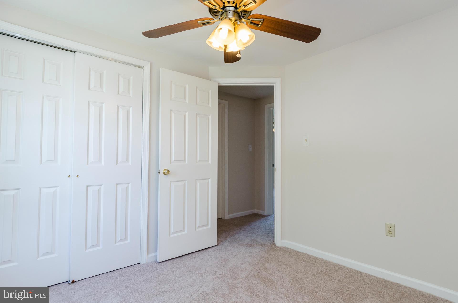 3123 Ripple Road Baltimore, MD 21244 - Photo 12 of 29 an empty room with chandelier fan and closet area