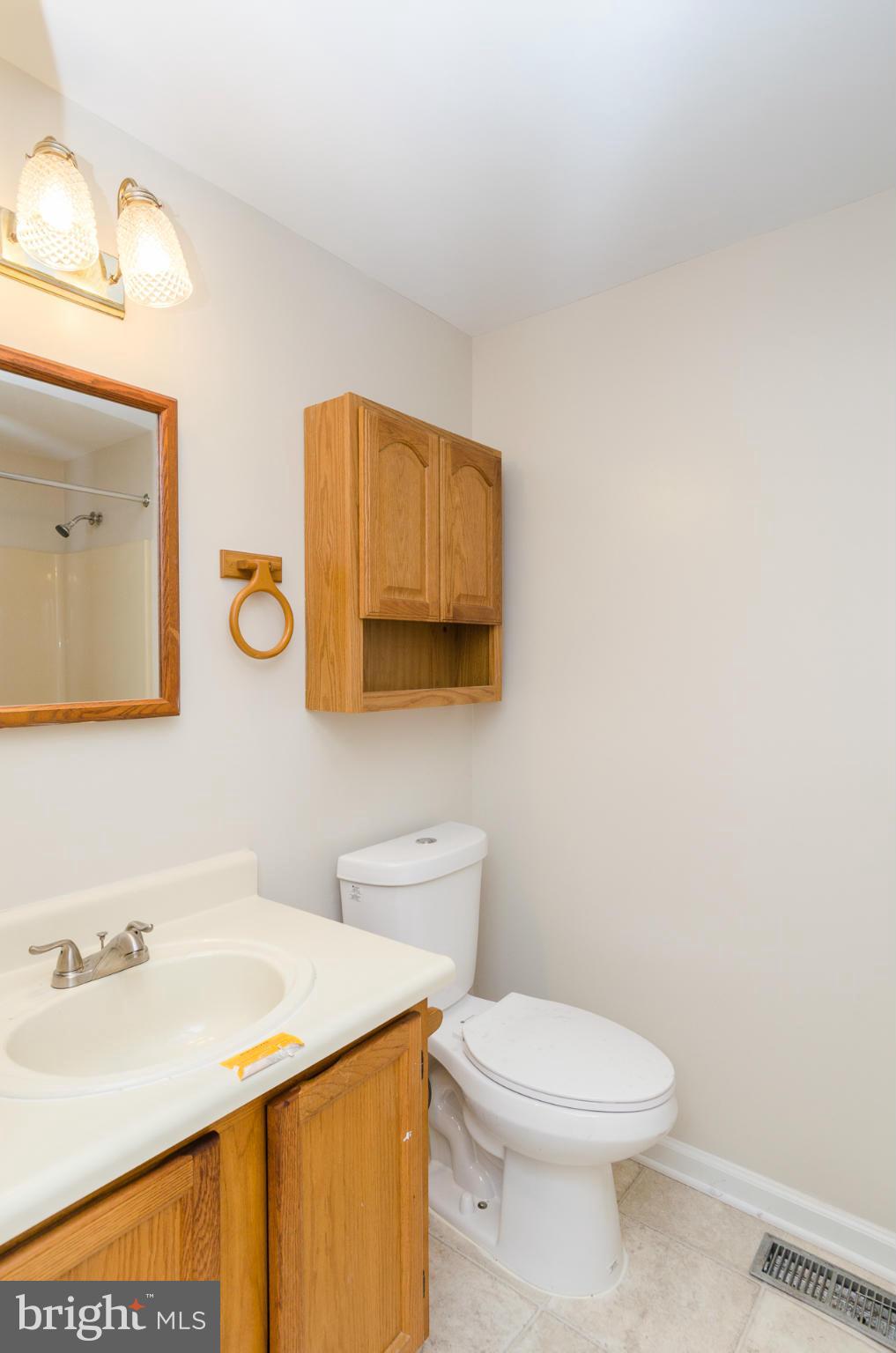 3123 Ripple Road Baltimore, MD 21244 - Photo 13 of 29 a bathroom with a sink a mirror and toilet