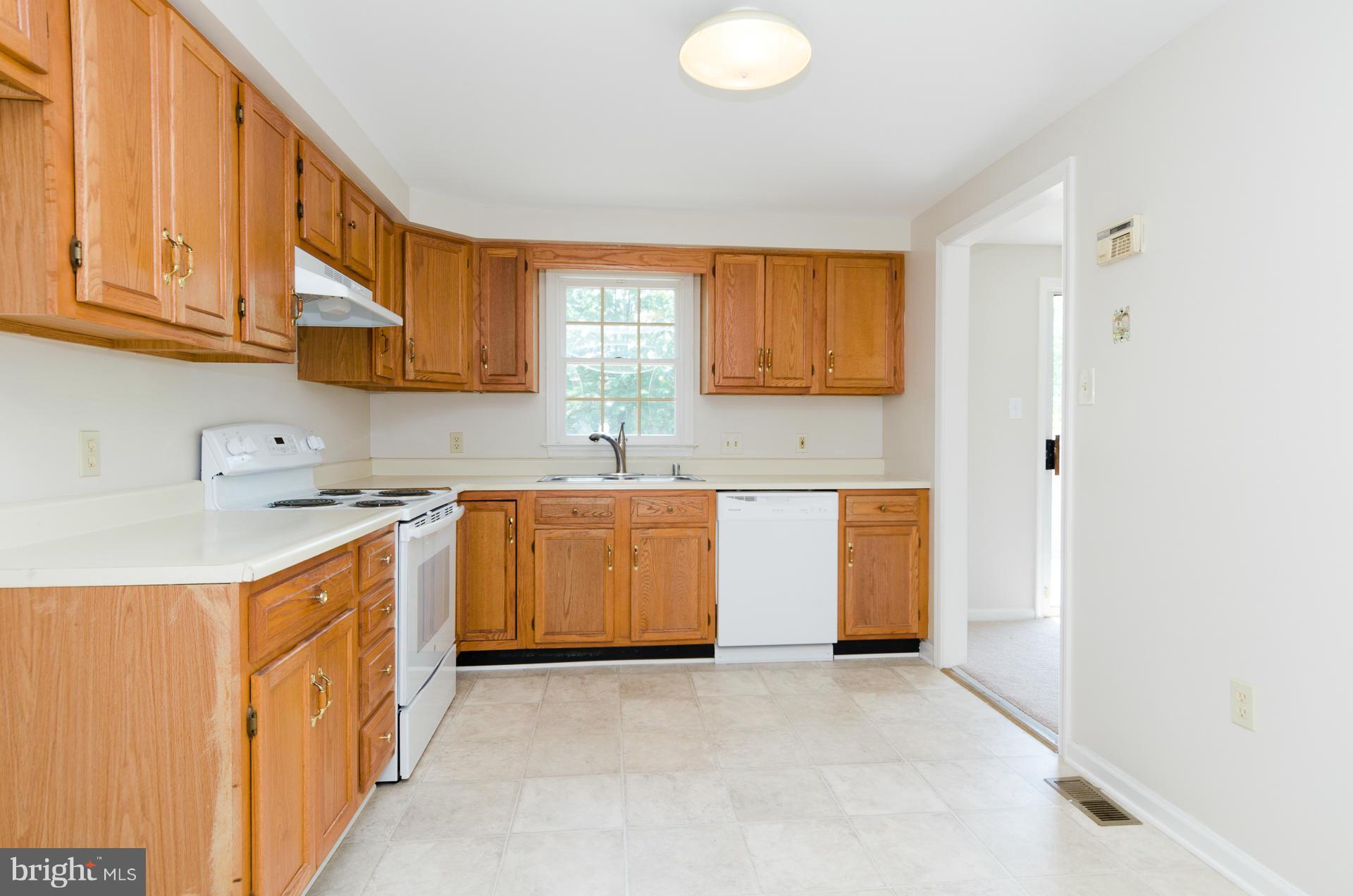 3123 Ripple Road Baltimore, MD 21244 - Photo 5 of 29 a kitchen with stainless steel appliances granite countertop a sink a stove and a refrigerator