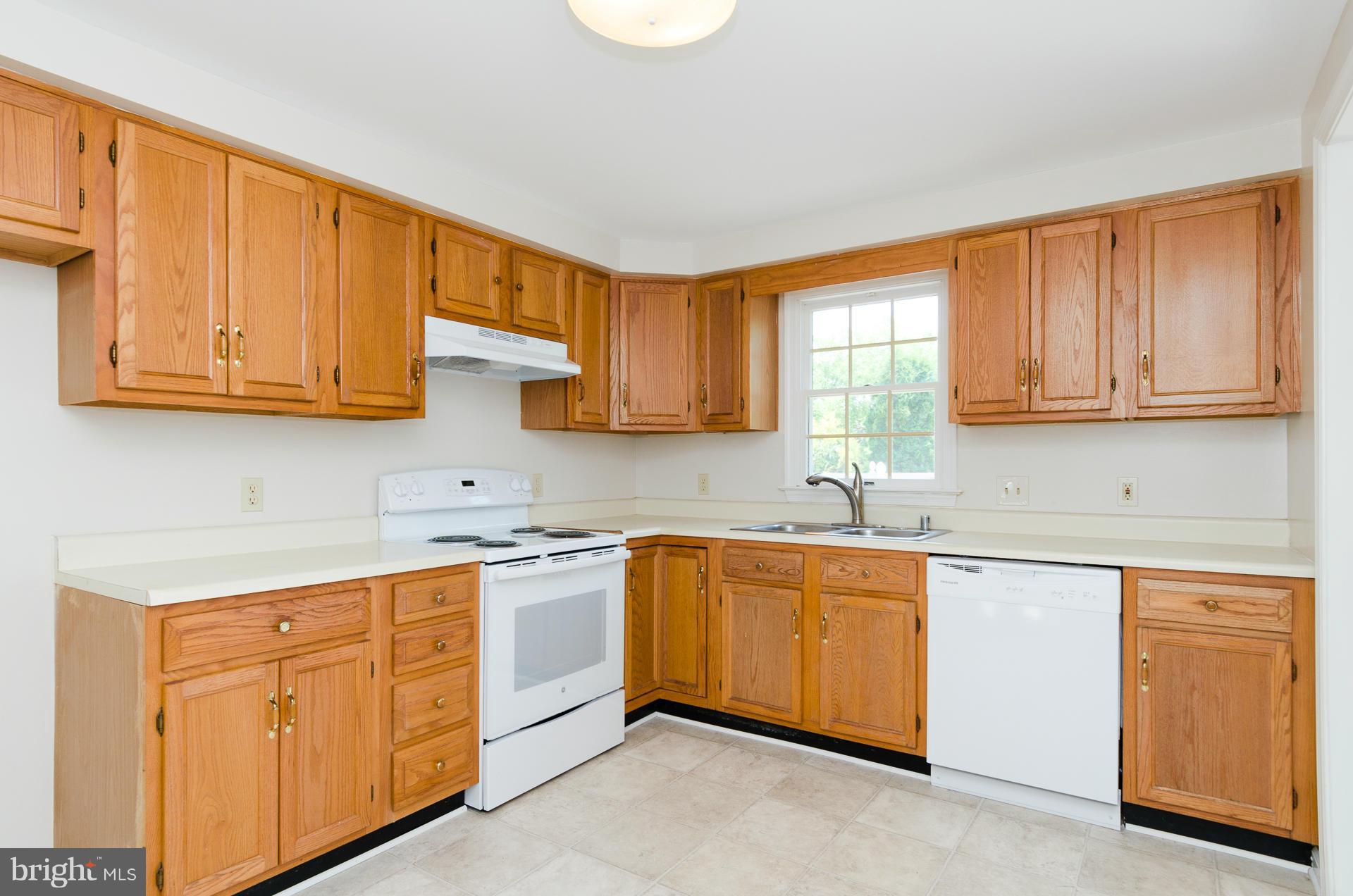 3123 Ripple Road Baltimore, MD 21244 - Photo 6 of 29 a kitchen with stainless steel appliances granite countertop a sink stove and cabinets