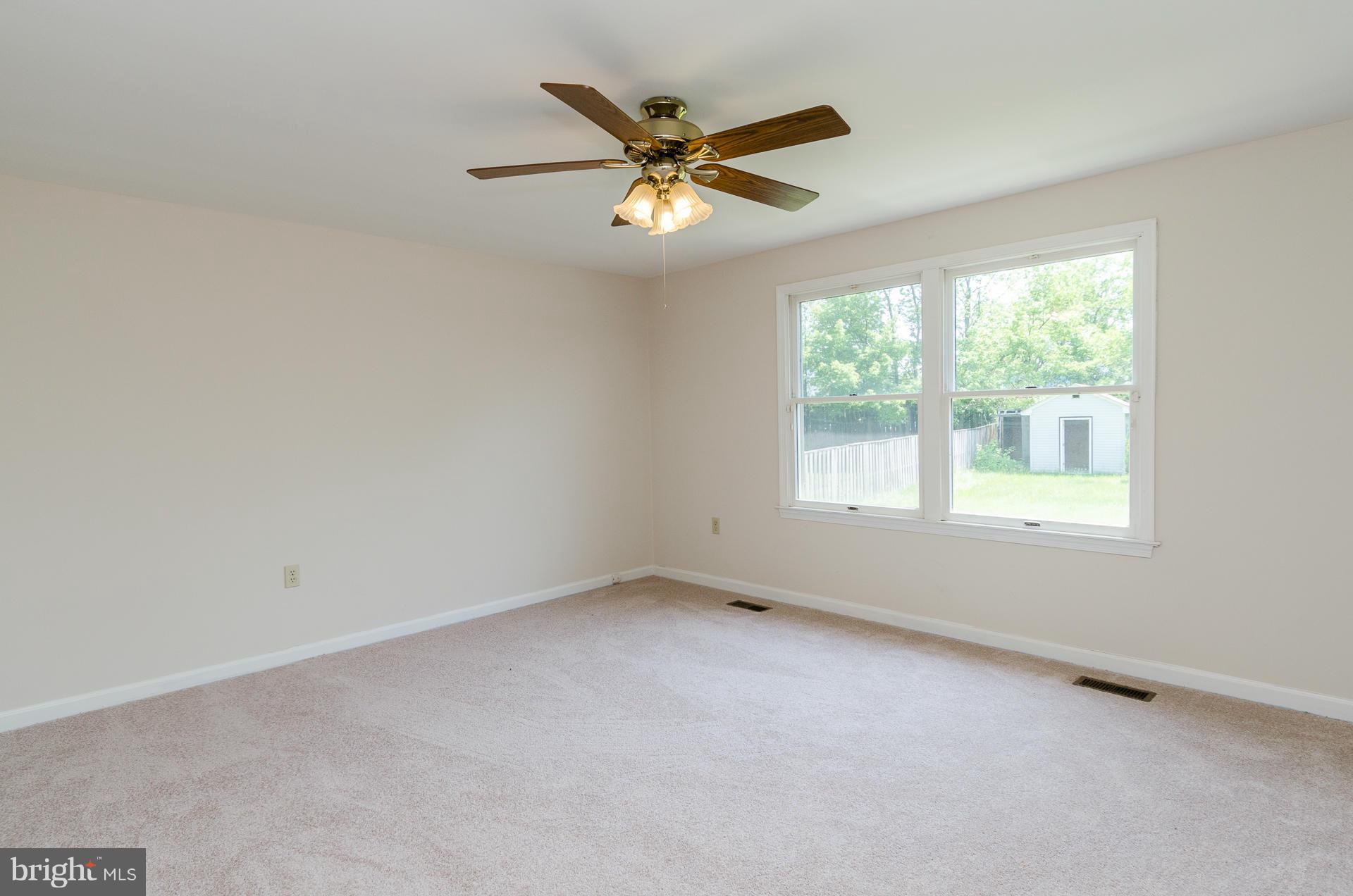 3123 Ripple Road Baltimore, MD 21244 - Photo 7 of 29 an empty room with a ceiling fan and window
