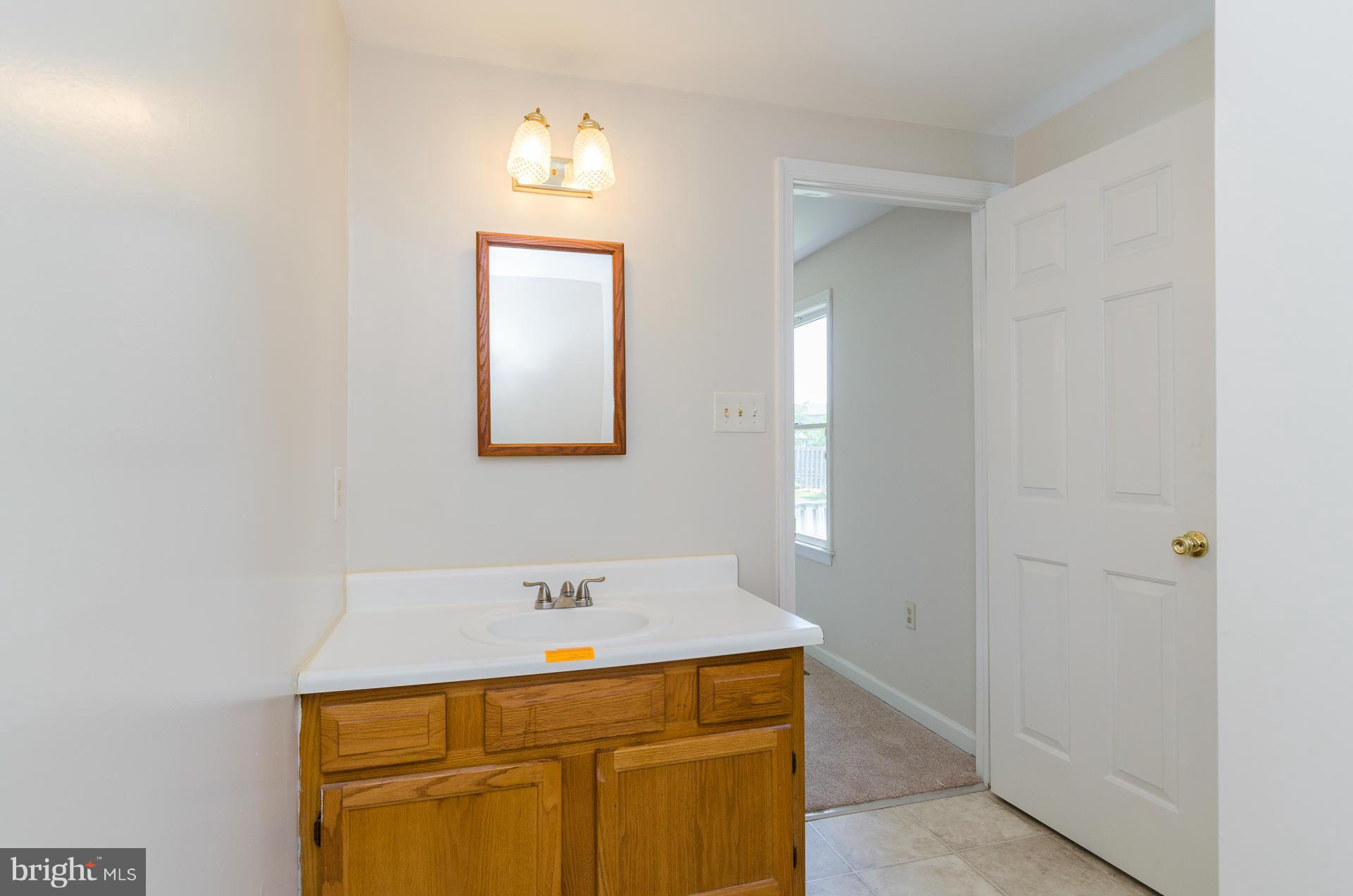 3123 Ripple Road Baltimore, MD 21244 - Photo 10 of 29 a bathroom with a sink and a mirror