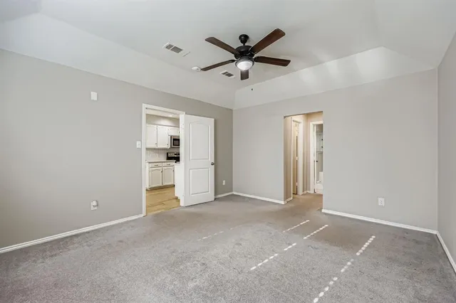 a view of a livingroom with a ceiling fan & entryway