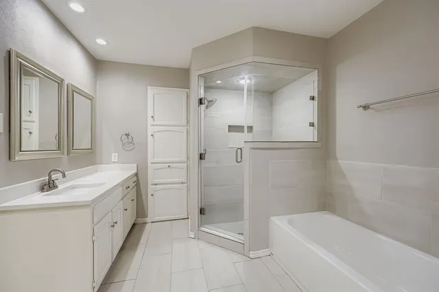 a spacious bathroom with a granite countertop sink mirror and shower