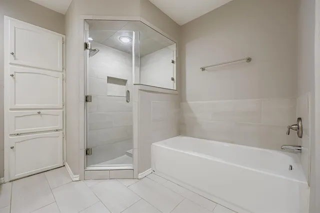 a bathroom with a bathtub and a shower