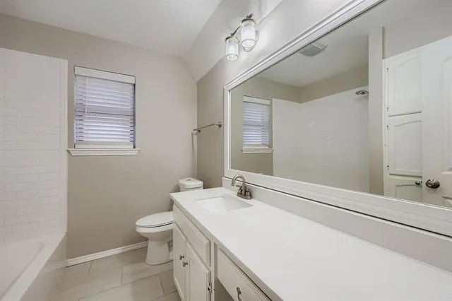 a bathroom with a sink a toilet and mirror
