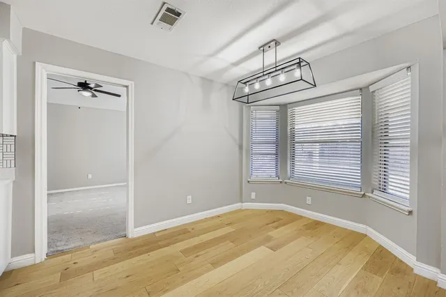 a view of a room with a wooden floor and a window
