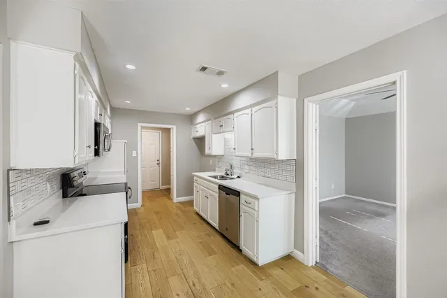 a kitchen with stainless steel appliances granite countertop a stove and a refrigerator