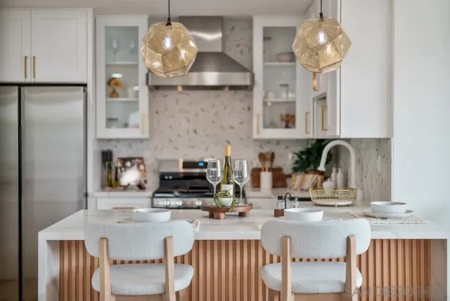 a kitchen with stainless steel appliances a stove a refrigerator and cabinets