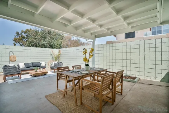 a view of a backyard with plants and a patio