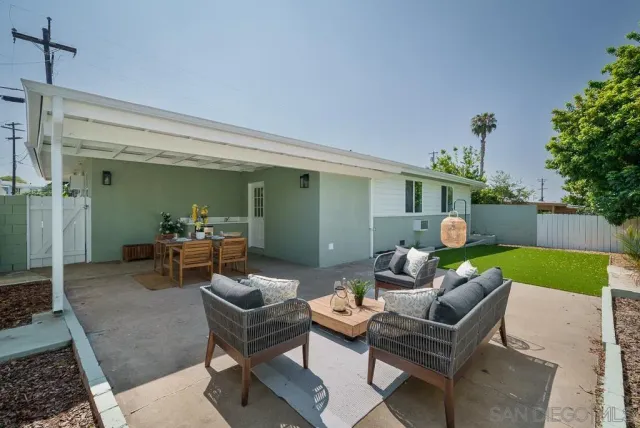 a view of a house with a yard and potted plants