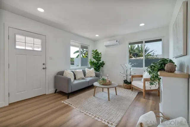 a living room with furniture and a potted plant