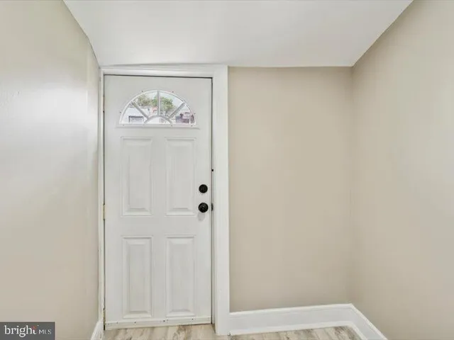 a view of a livingroom with wooden floor and a window