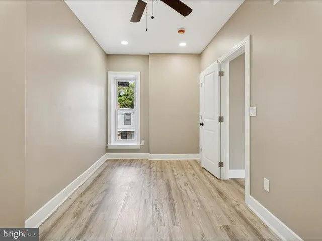 wooden floor in an empty room with a window