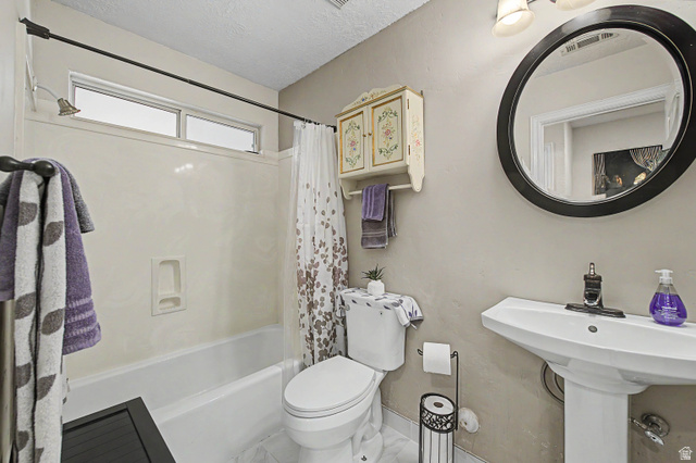 3034 Swiss Drive Santa Clara, UT 84765 - Photo 29 of 59 Bathroom featuring a pedestal sink, white toilet, and a bathtub with an integrated shower