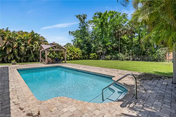 a view of a swimming pool with a yard