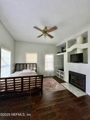 a living room with furniture a fireplace and a flat screen tv