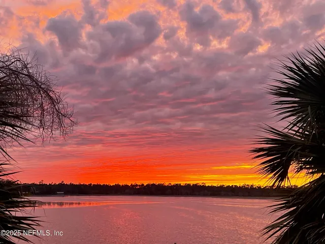 a bedroom with a bed mirror and window