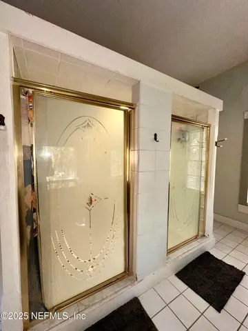 a bathroom with a granite countertop shower