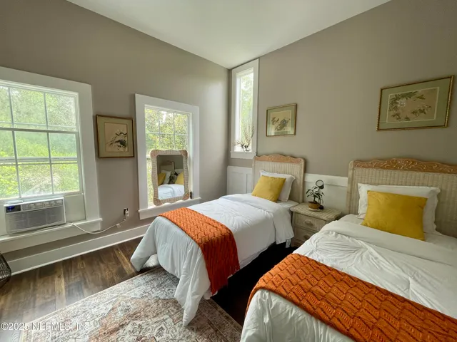 a bedroom with a bed and a flat tv screen on dresser