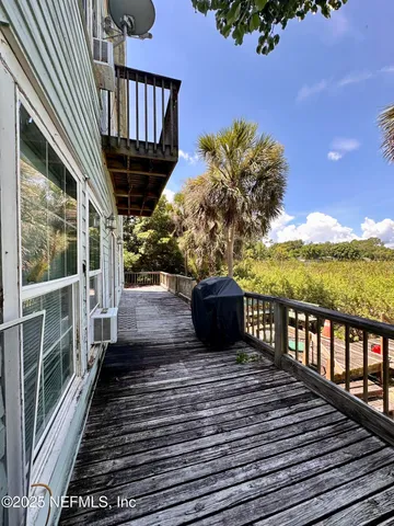 a view of a chairs and tables in the back yard of the house