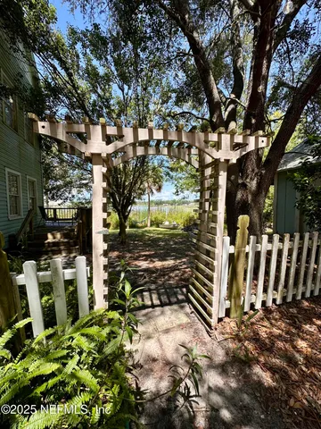 a view of a hallway with wooden floors and a large window