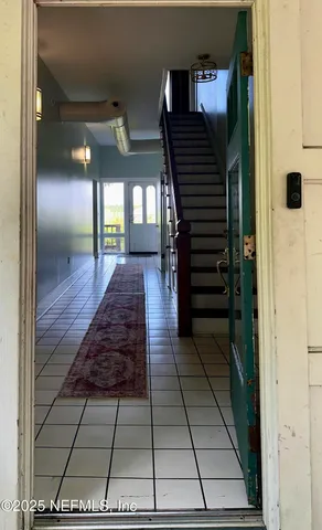 a view of entryway and hall with a rug