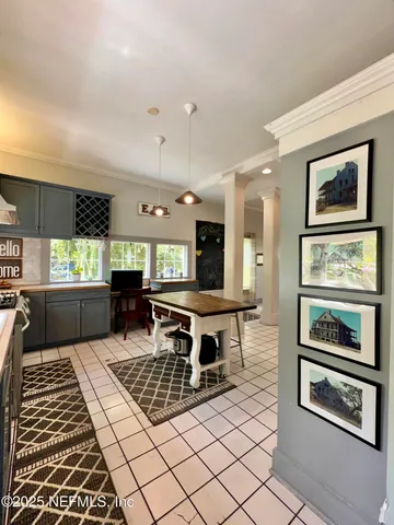 a living room with stainless steel appliances kitchen island granite countertop a stove a sink and a refrigerator