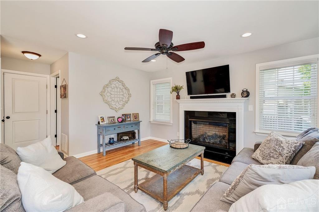 341 Dunellen Avenue Dunellen, NJ 08812 - Photo 11 of 24 a living room with furniture a fireplace and a flat screen tv