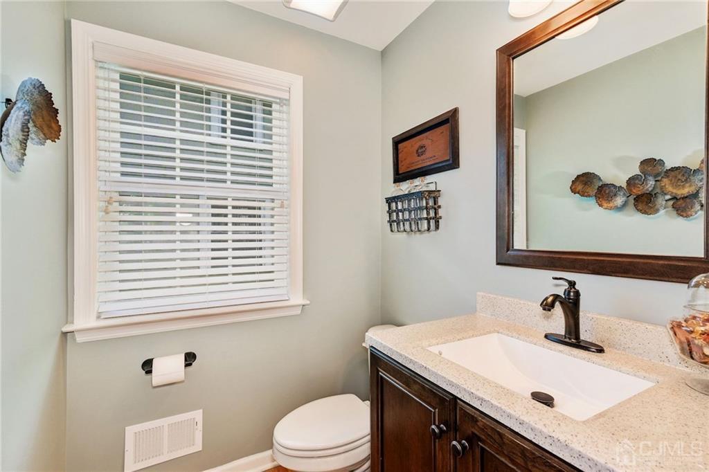341 Dunellen Avenue Dunellen, NJ 08812 - Photo 13 of 24 a bathroom with a sink a toilet and a window