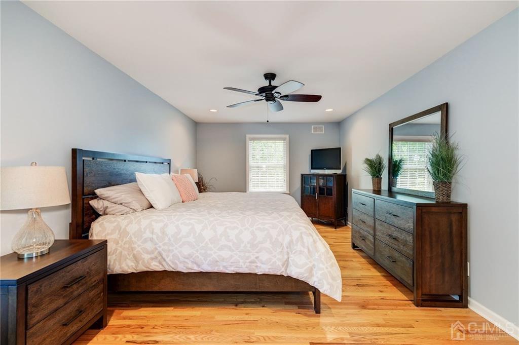 341 Dunellen Avenue Dunellen, NJ 08812 - Photo 14 of 24 a bedroom with a large bed and a tv