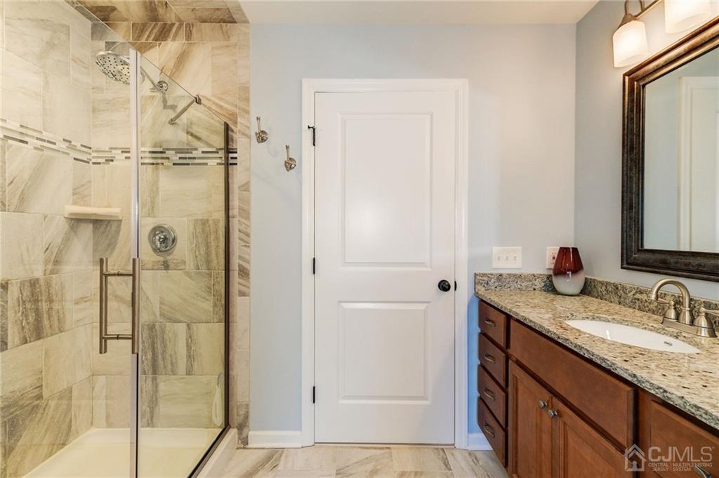 341 Dunellen Avenue Dunellen, NJ 08812 - Photo 16 of 24 a bathroom with a granite countertop sink and shower