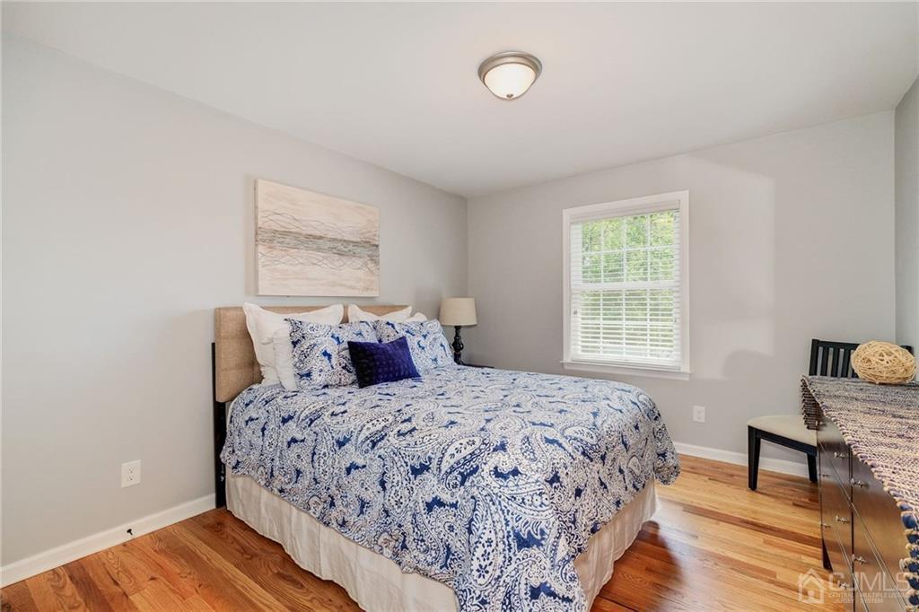 341 Dunellen Avenue Dunellen, NJ 08812 - Photo 17 of 24 a bedroom with a bed and wooden floor