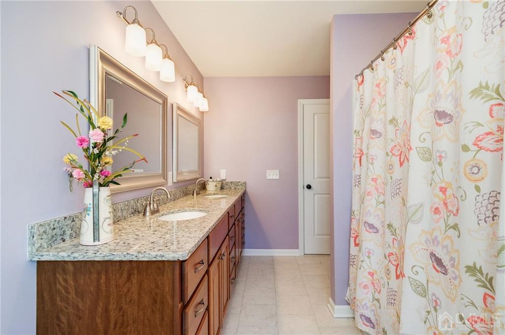 341 Dunellen Avenue Dunellen, NJ 08812 - Photo 20 of 24 a bathroom with a granite countertop sink a vanity and a mirror