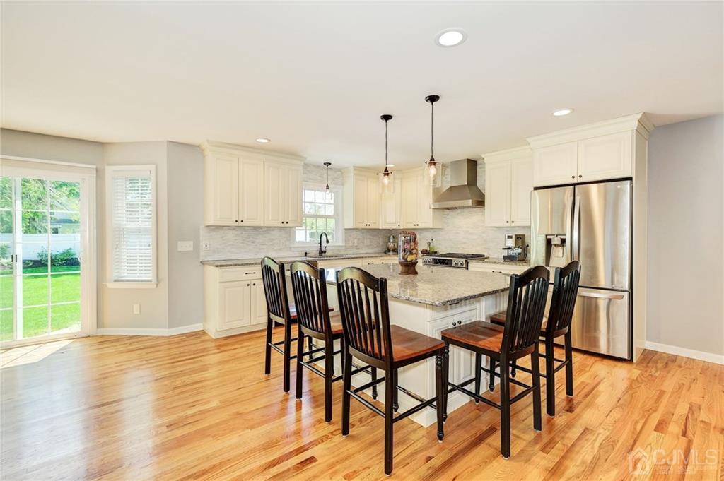 341 Dunellen Avenue Dunellen, NJ 08812 - Photo 5 of 24 a kitchen with stainless steel appliances granite countertop a dining table chairs refrigerator and sink