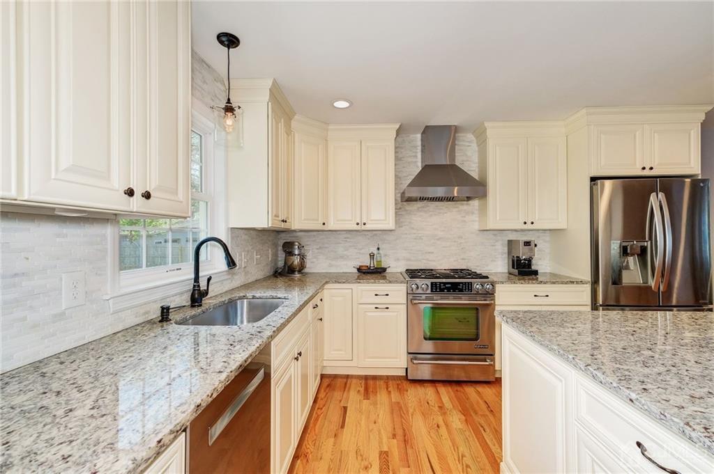 341 Dunellen Avenue Dunellen, NJ 08812 - Photo 7 of 24 a kitchen with stainless steel appliances granite countertop a sink stove and refrigerator