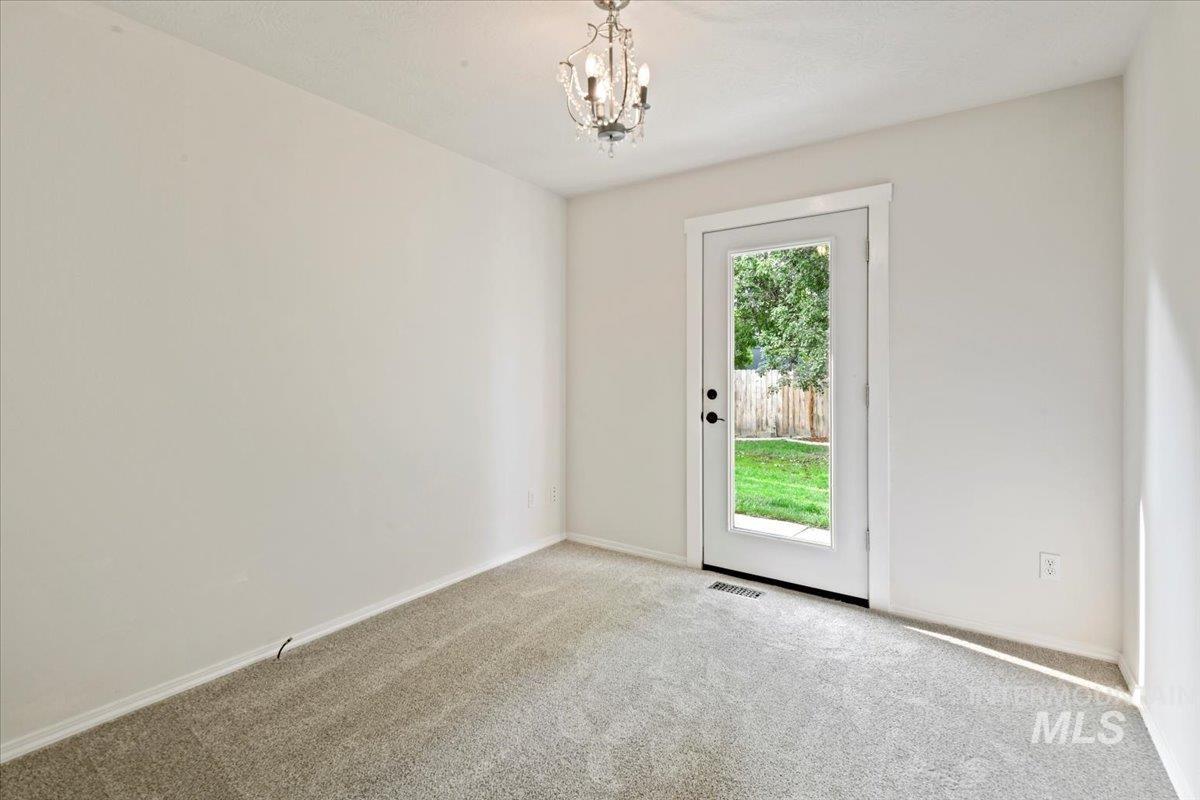 12019 West Rader Drive Boise, ID 83713 - Photo 15 of 41 This flex room highlights new carpet and access to the backyard