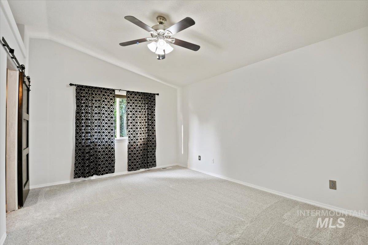 12019 West Rader Drive Boise, ID 83713 - Photo 19 of 41 Renovated primary bedroom ensuite with barn doors to bathroom