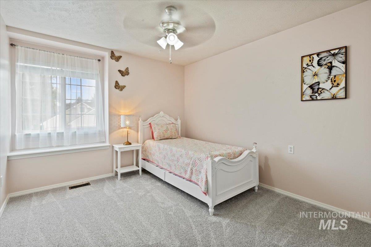 12019 West Rader Drive Boise, ID 83713 - Photo 24 of 41 Upstairs bedroom featuring new carpet, fan and bench window seating