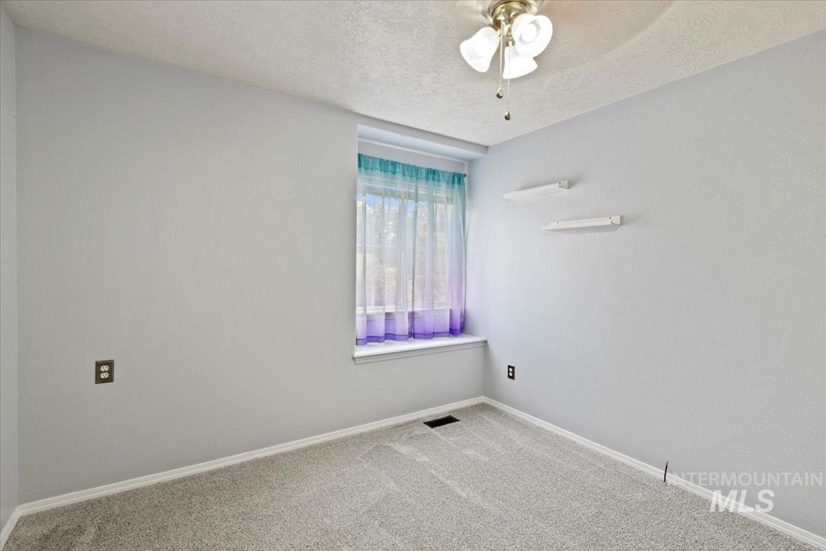 12019 West Rader Drive Boise, ID 83713 - Photo 25 of 41 Upstairs bedroom with new carpet and fan with bench seating at window