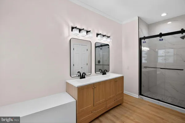 a bathroom with a sink a mirror and a shower