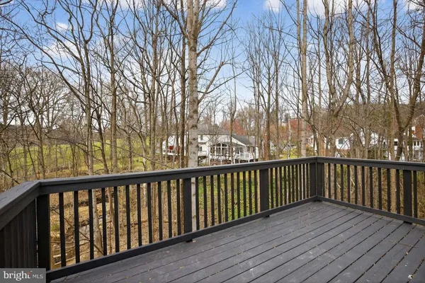 a view of balcony with wooden floor and fence