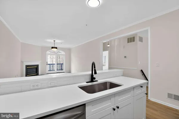a kitchen with a sink and a stove top oven