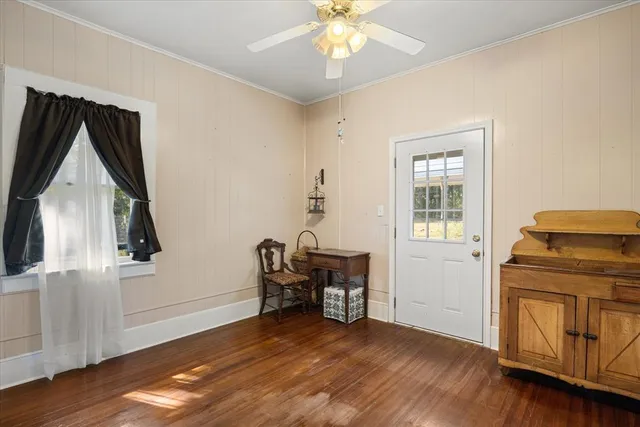 a view of a livingroom with furniture wooden floor and staircase