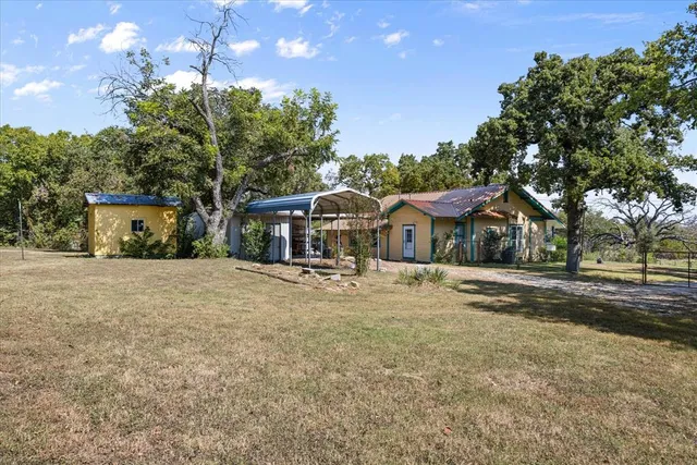 a view of a house with yard and sitting area