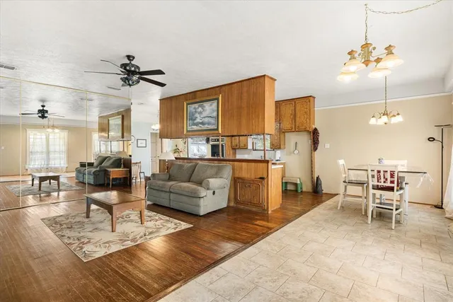 a living room with furniture and a chandelier